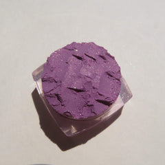 Hand applying Jessica Pure Mineral Eyeshadow in purple shimmer as loose pigment with a brush