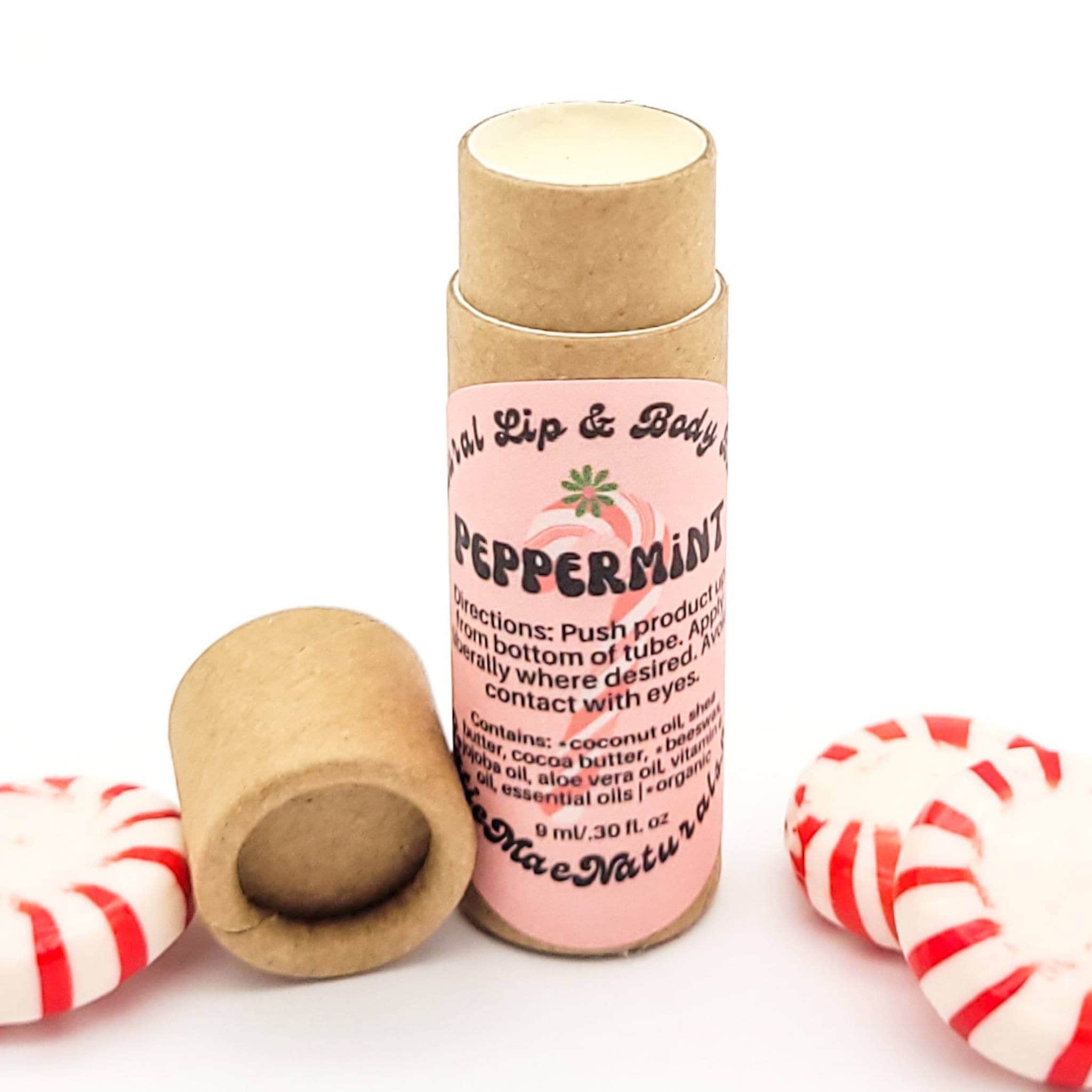 Lip balm tube with pink label, brown cardboard, and peppermint candies alongside Mae Naturals brand