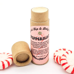 Lip balm tube with pink label, brown cardboard, and peppermint candies alongside Mae Naturals brand