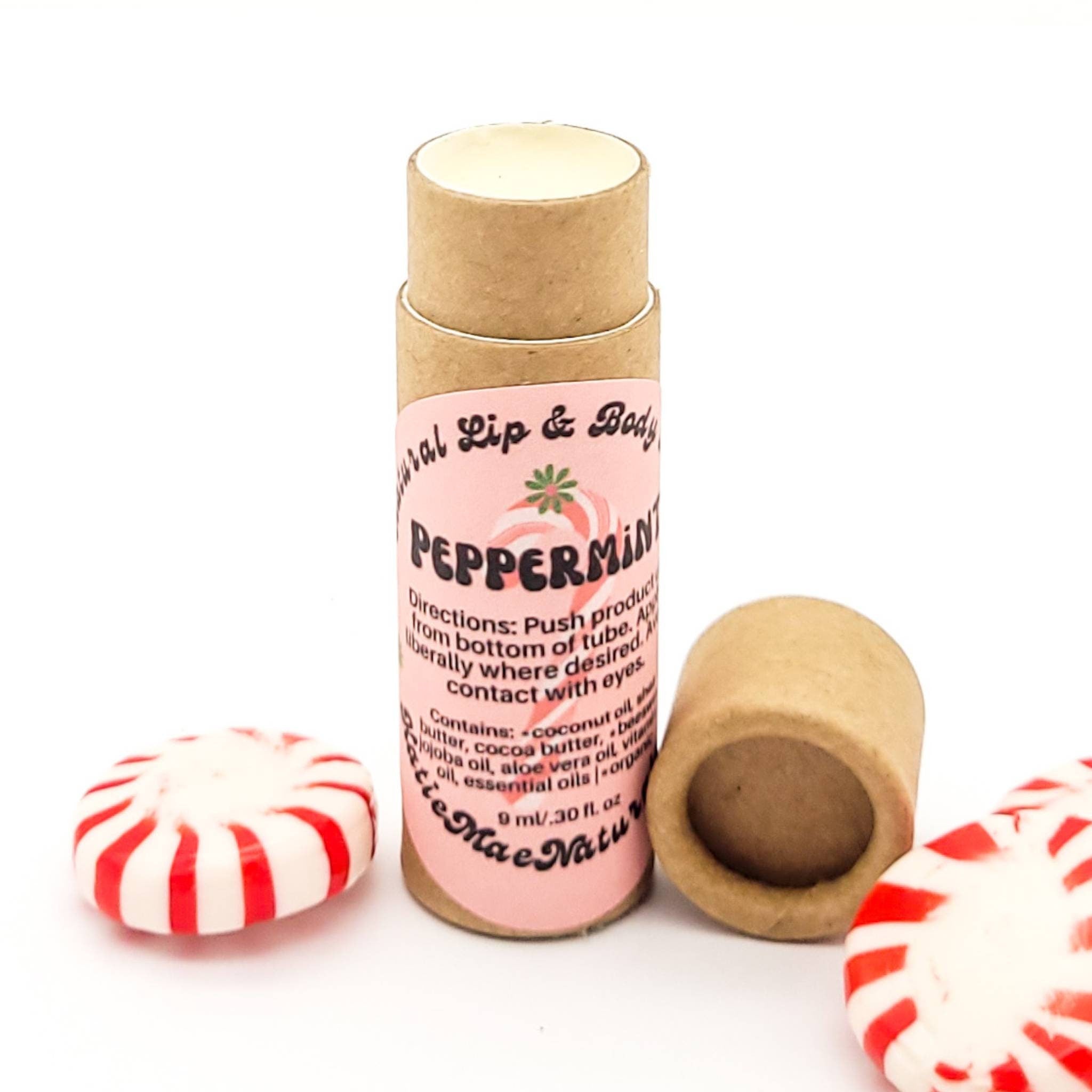 Lip balm tube with pink label, brown cardboard, and peppermint candies with red stripes