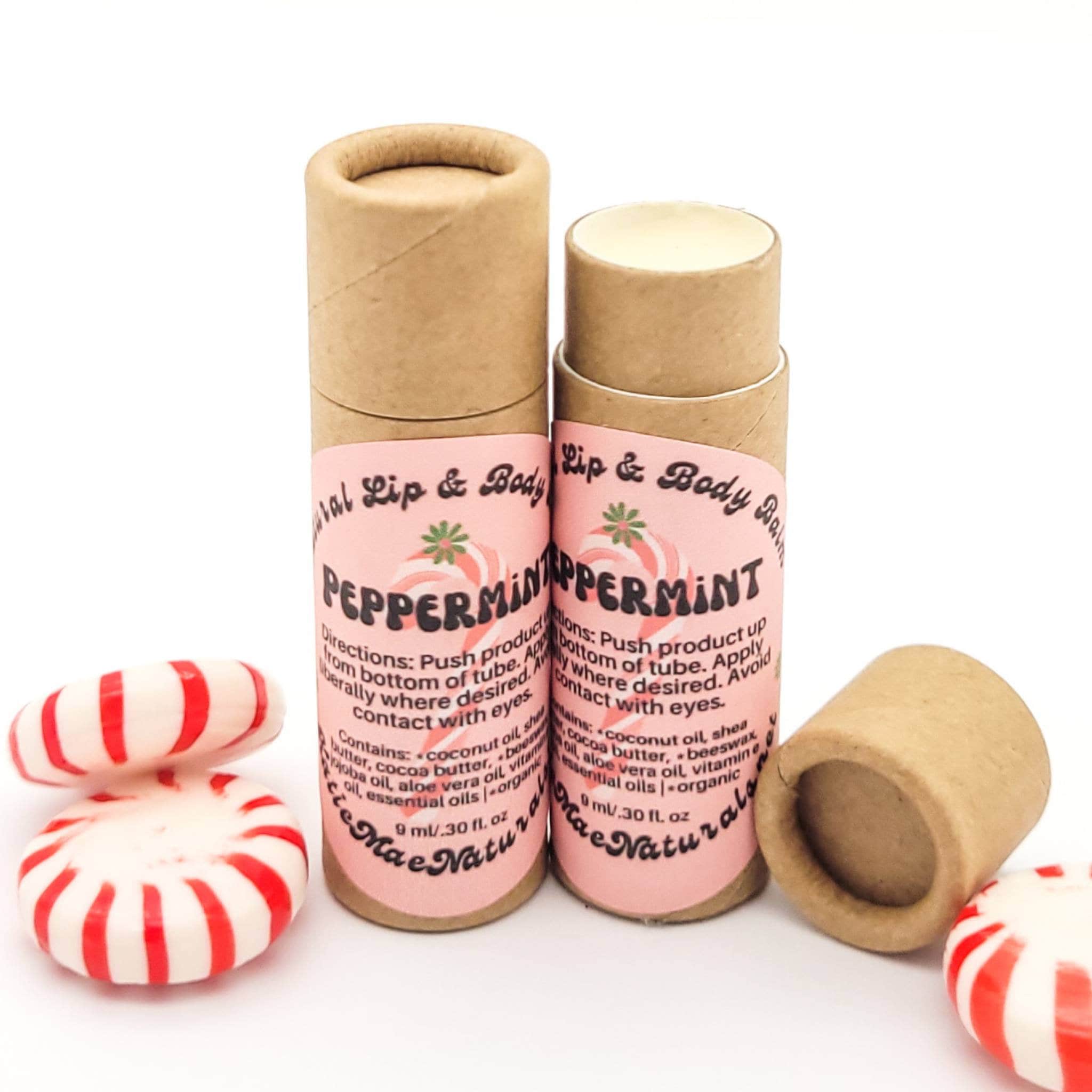 Lip balm tubes in brown cardboard with pink label and peppermint candies, Mae Naturals brand