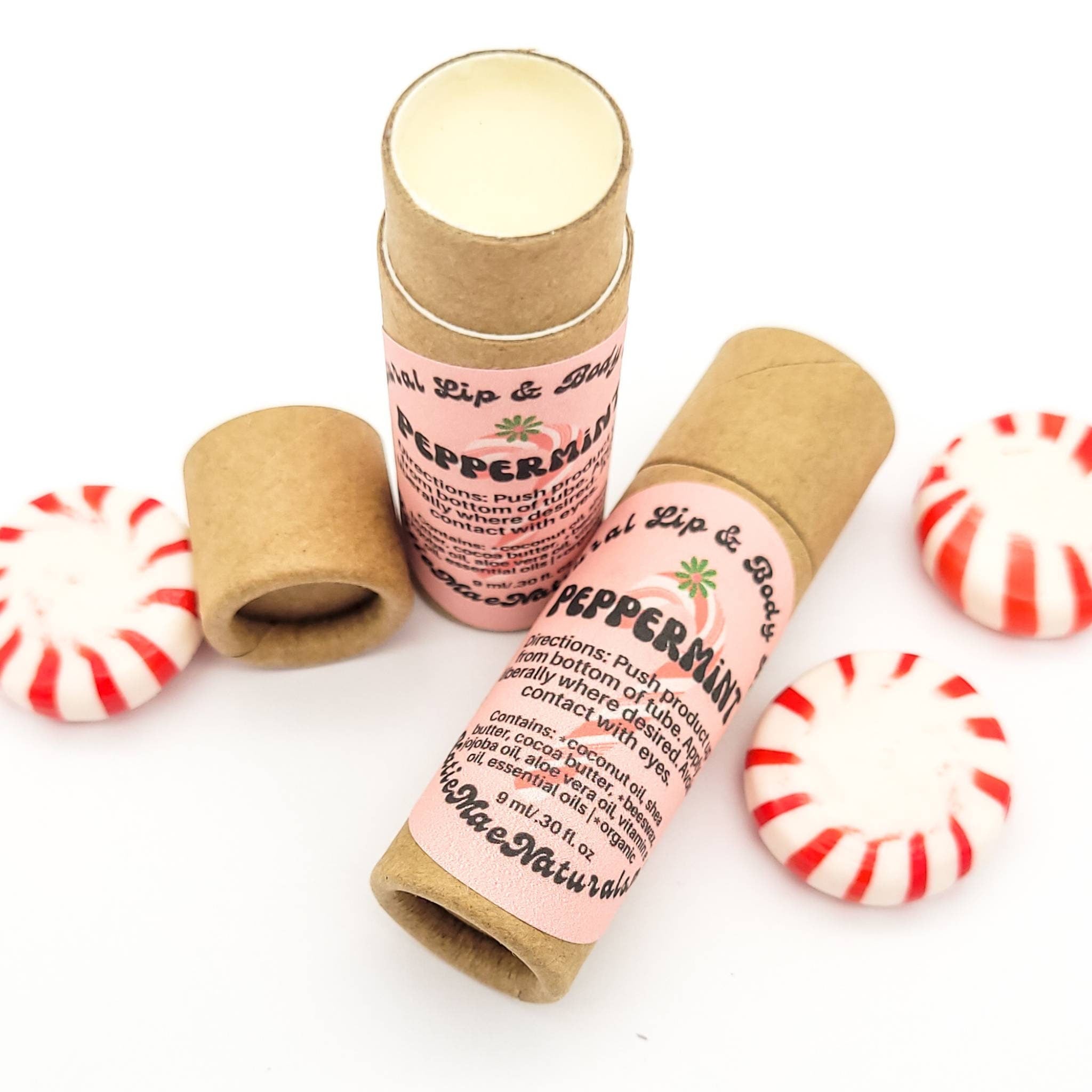 Lip balm tubes with pink label, brown paper, and peppermint candies with red stripes
