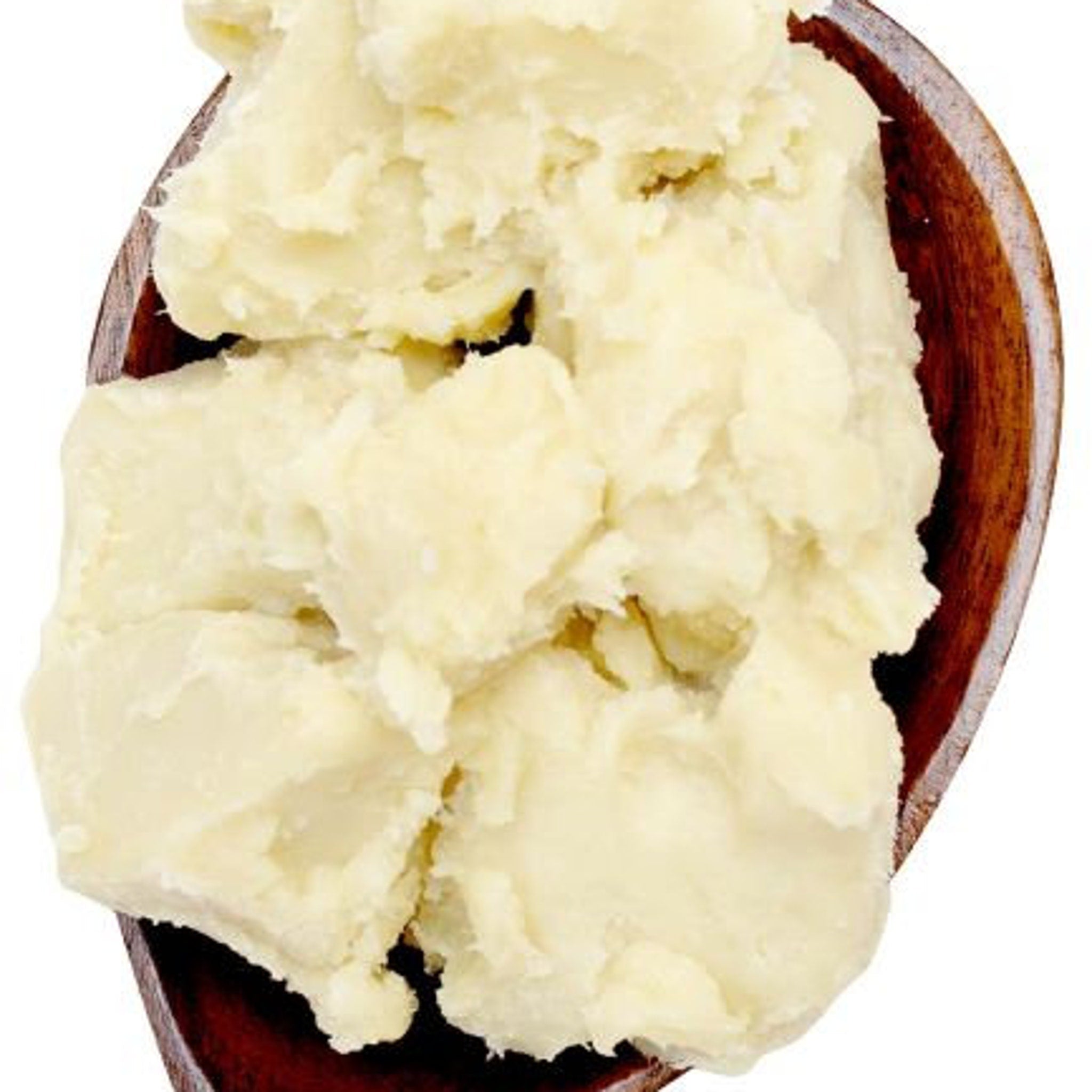Hand scooping rich golden shea butter from a glass jar onto fingertips for skin application