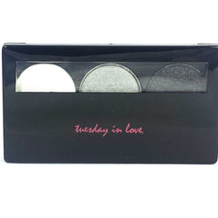 Close-up of three shimmery silver eyeshadow pans with varying metallic finishes in sleek black compact.