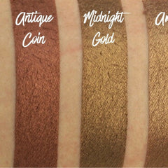 Close-up of a makeup brush applying vegan chocolate brown shimmer eyeshadow with metallic finish to eyelid