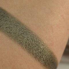 Side angle view of army green shimmer pressed pigment in round pan with metallic finish