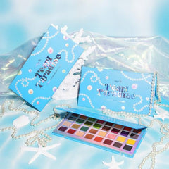Open Pearl Paradise eyeshadow palette displaying 32 vibrant shades in matte, shimmer, and metallic finishes with mirror