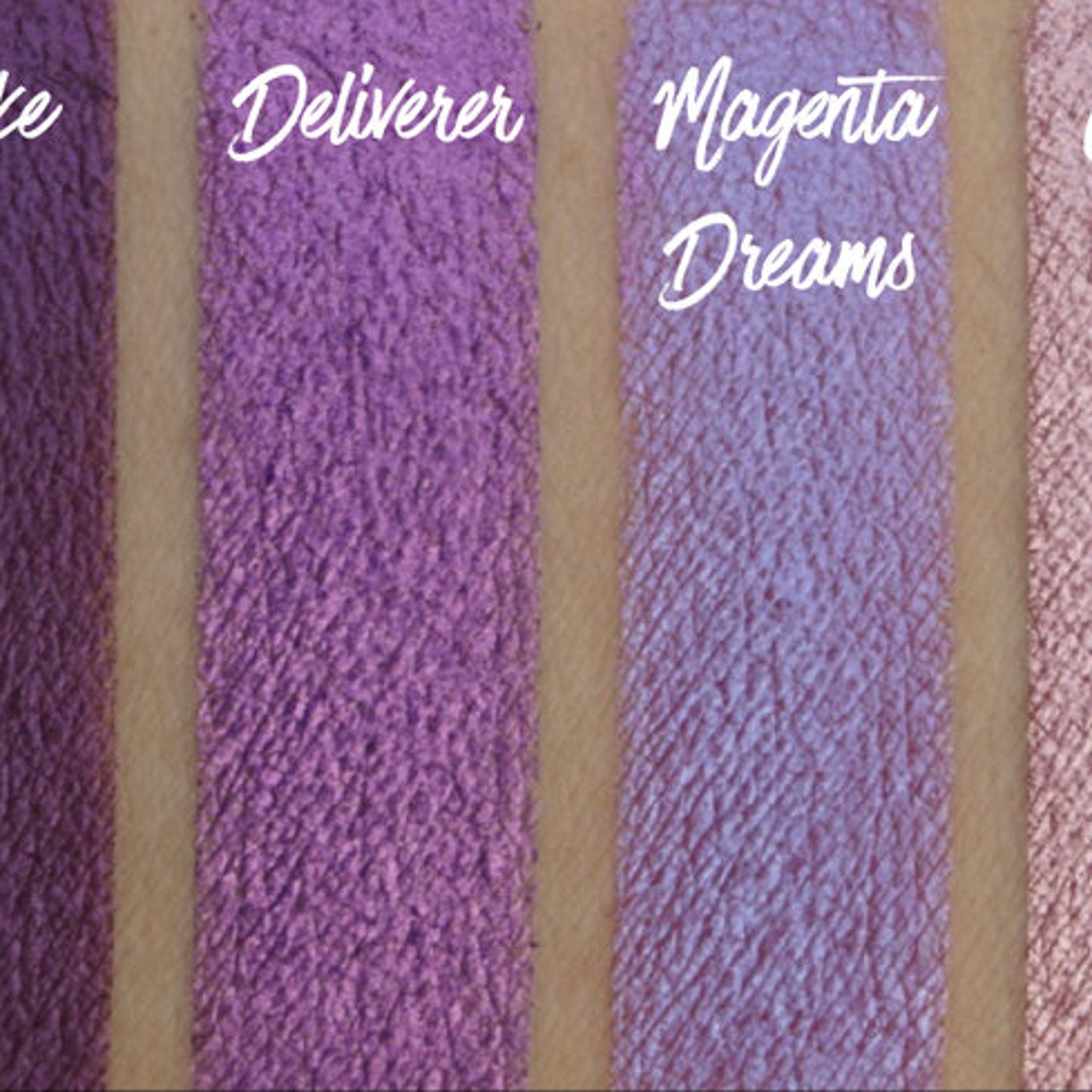 Purple eyeshadow swatches with Deliverer and Magenta Dreams text, textured finish on skin