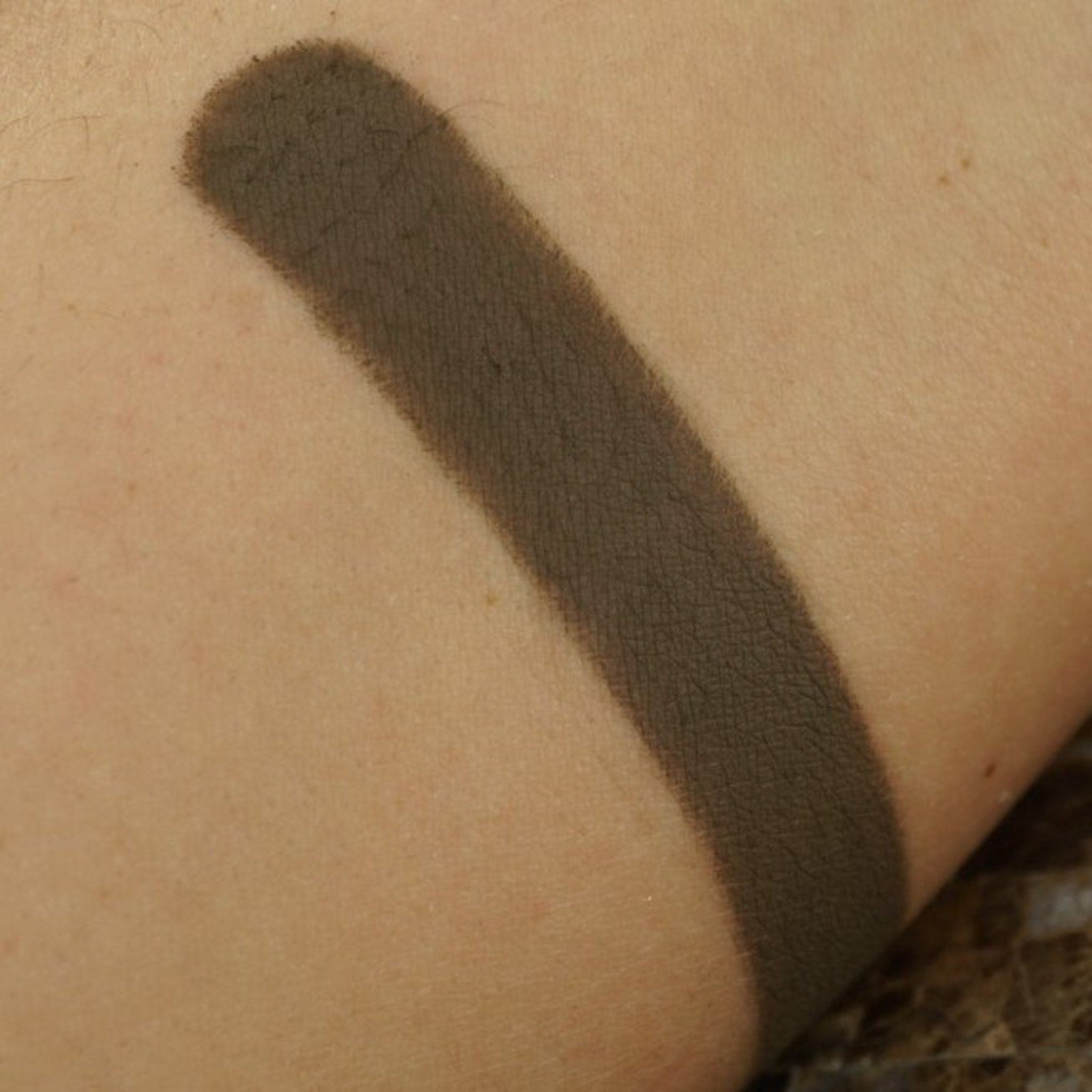 Close-up of matte pressed eyeshadow pan showing smooth, pigmented powder texture in a 26mm round compact