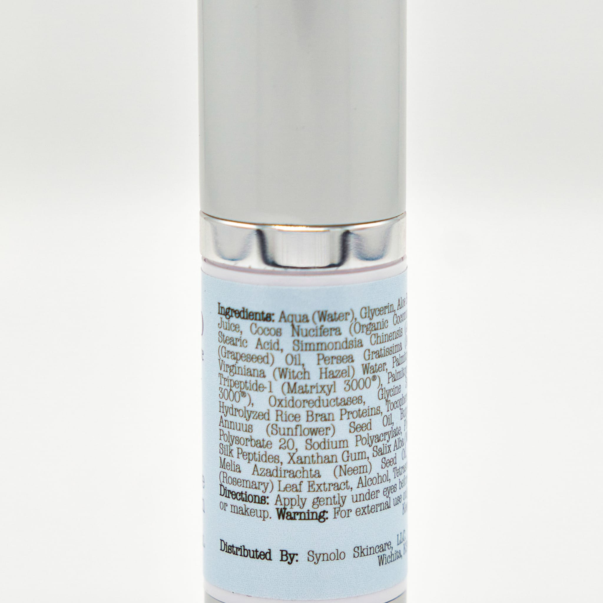 Skincare product bottle, silver and white, with blue label and text visible