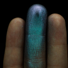 Side view of Grungy Blue to Purple Duochrome Eyeshadow pan catching light to reveal shimmer shift