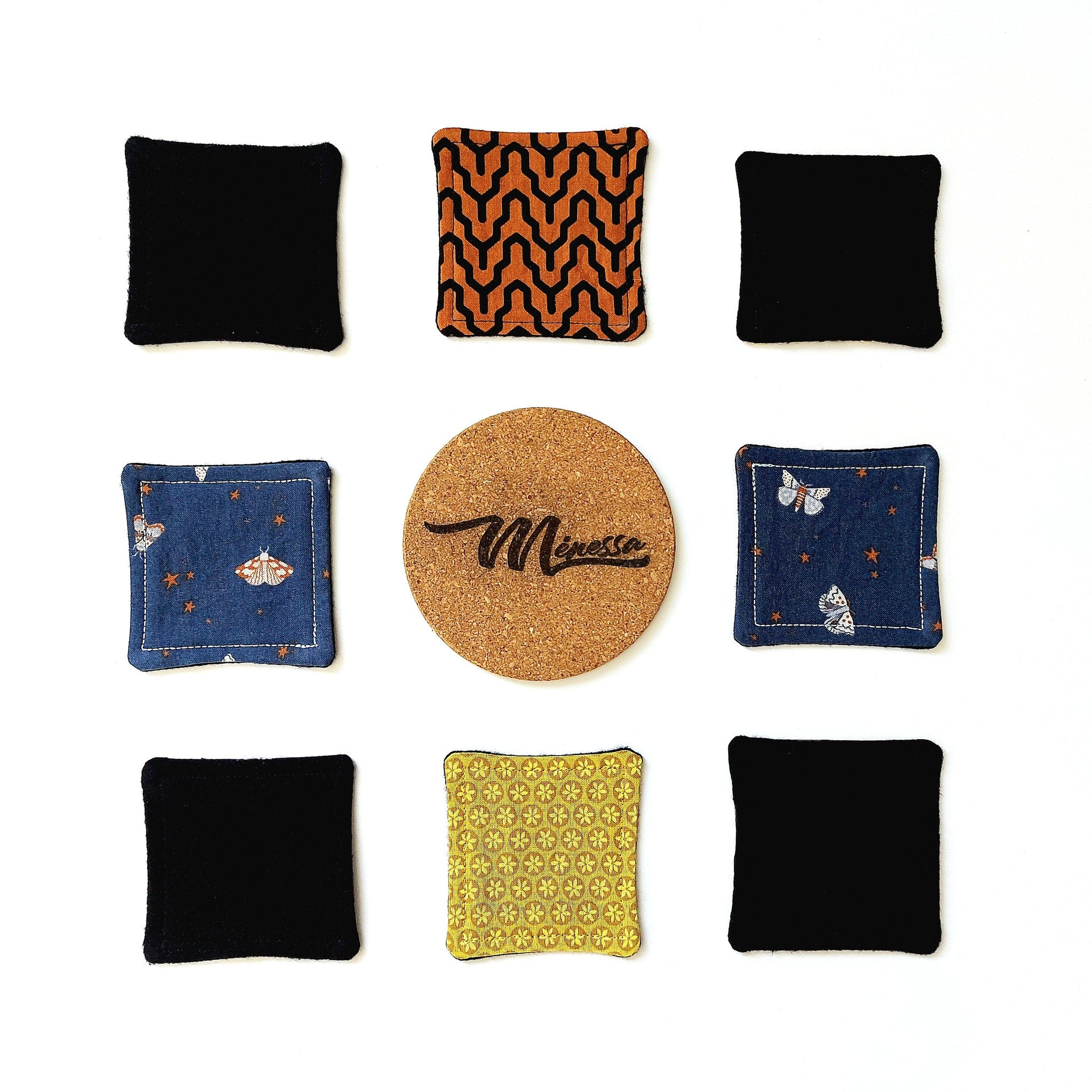 Coasters black fabric, orange pattern, blue butterfly print, and cork with Minessa brand name