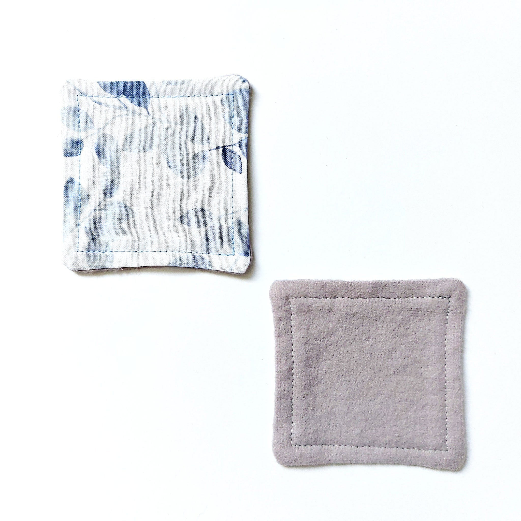 Coasters with blue floral pattern and gray felt material, square shape with stitched edges