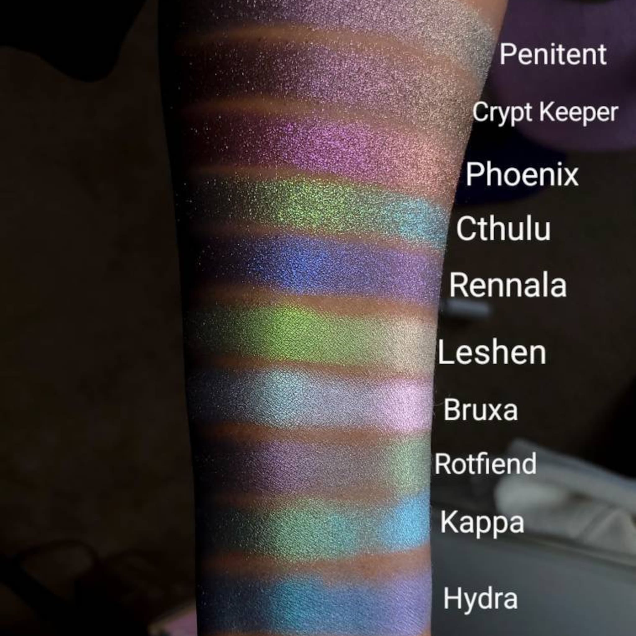 Eyeshadow swatches with iridescent shimmer in various colors on skin, for makeup application