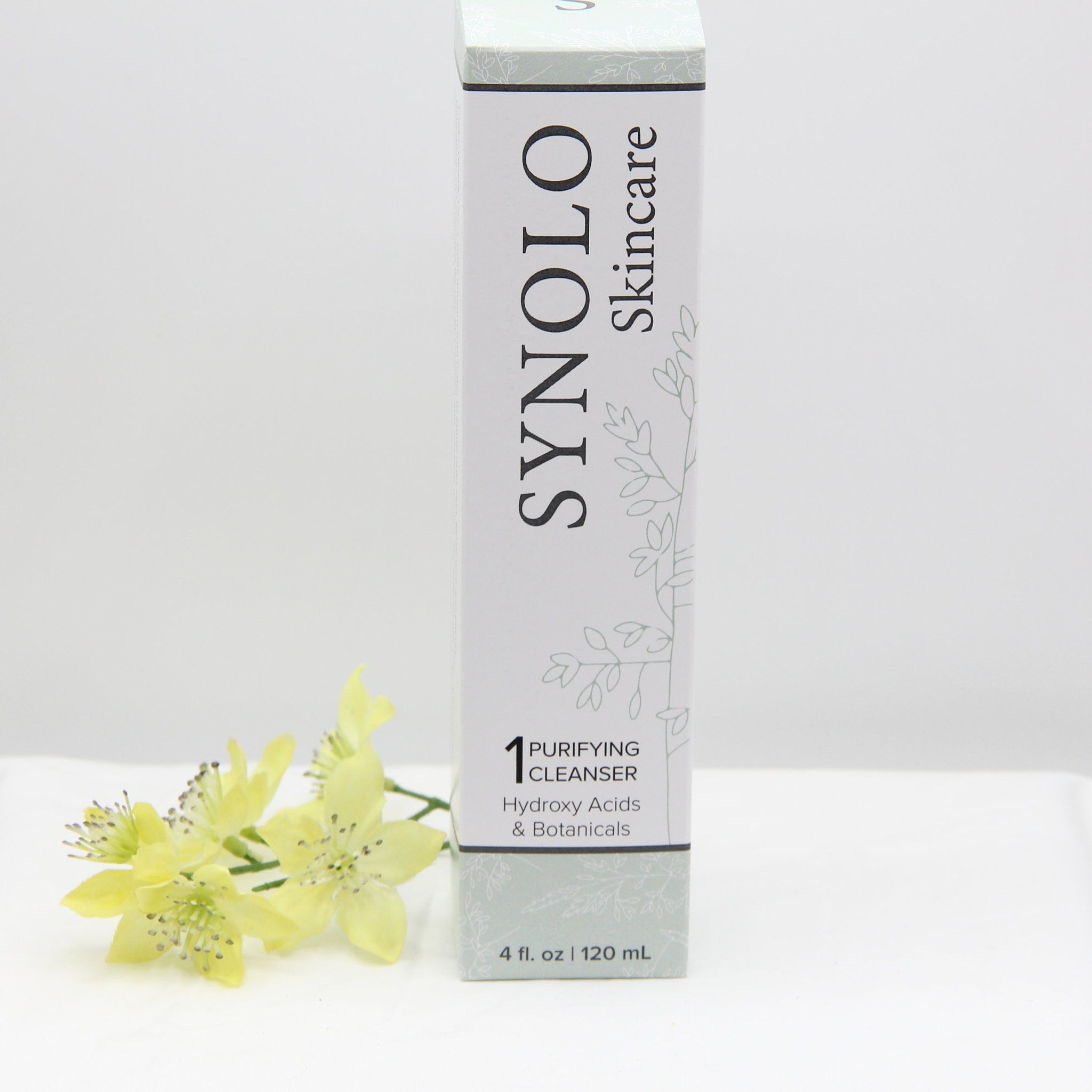 Facial Cleanser white rectangular box with Synolo Skincare text and floral pattern, with yellow flowers