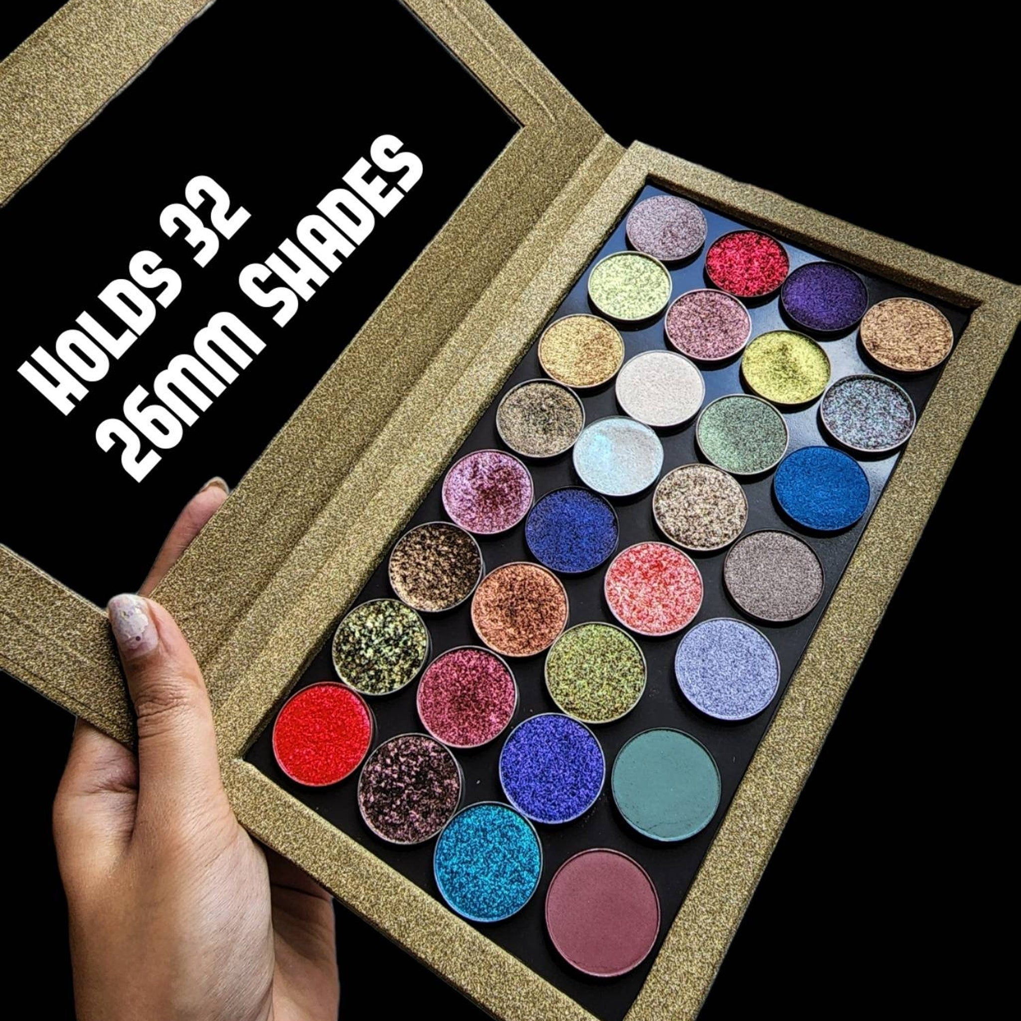 Close-up of multichrome pressed eyeshadow pans in sparkly golden glitter shades inside magnetic palette