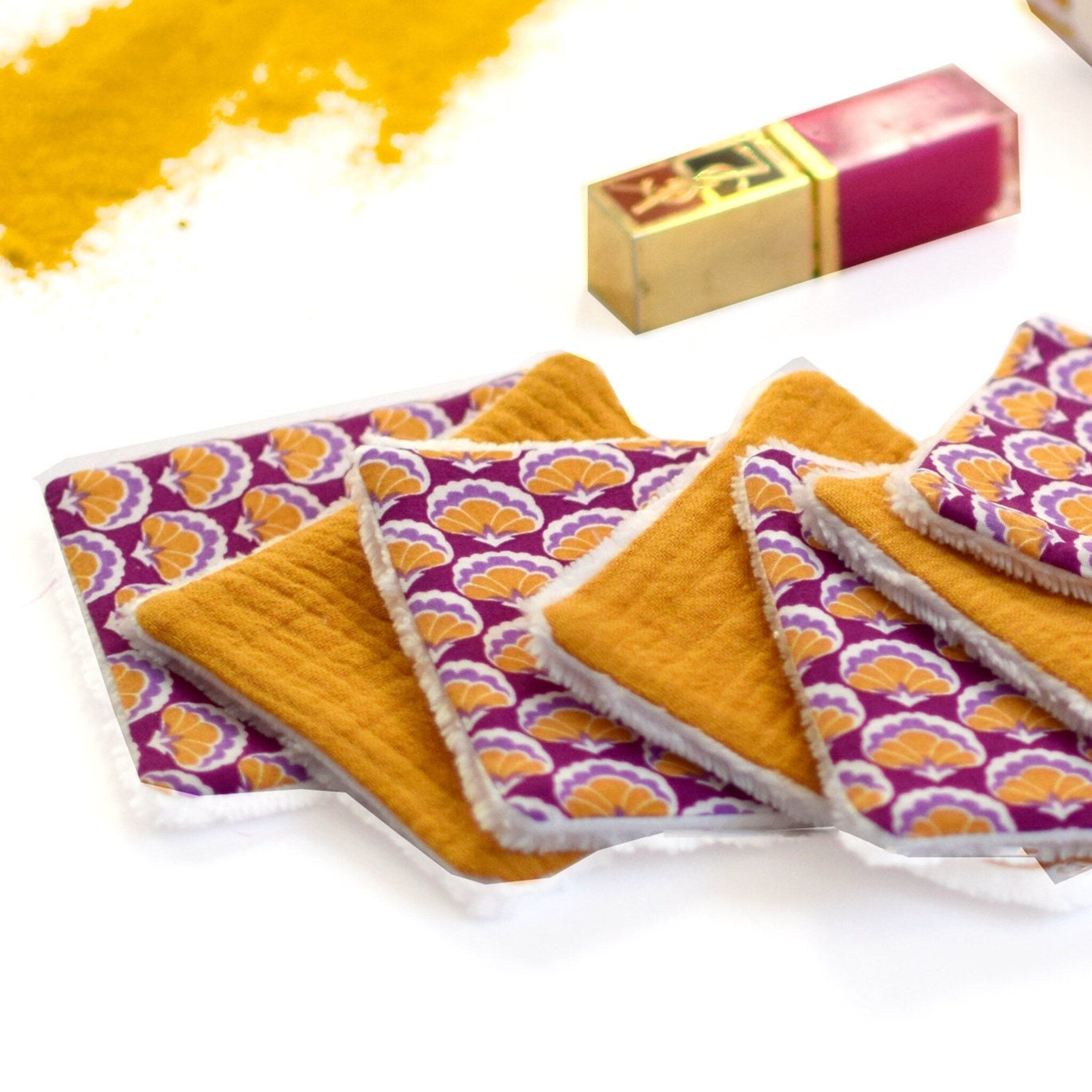 Reusable makeup remover pads with orange and purple floral pattern and yellow fabric