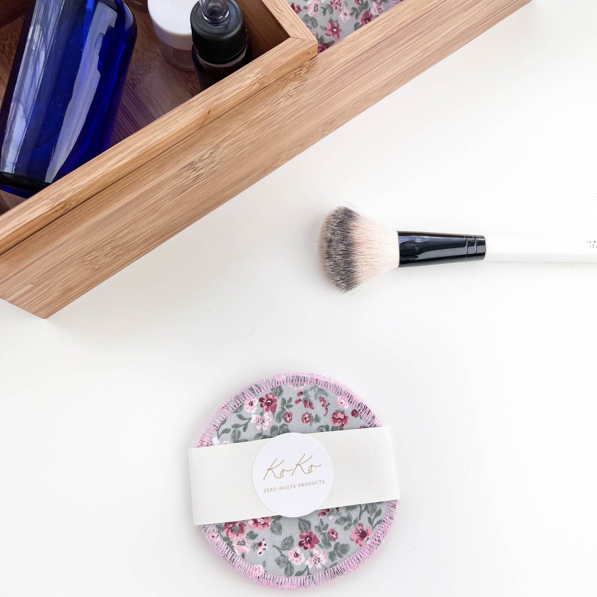 Reusable makeup remover pads with floral pattern, pink trim, and KoKo brand label on white background