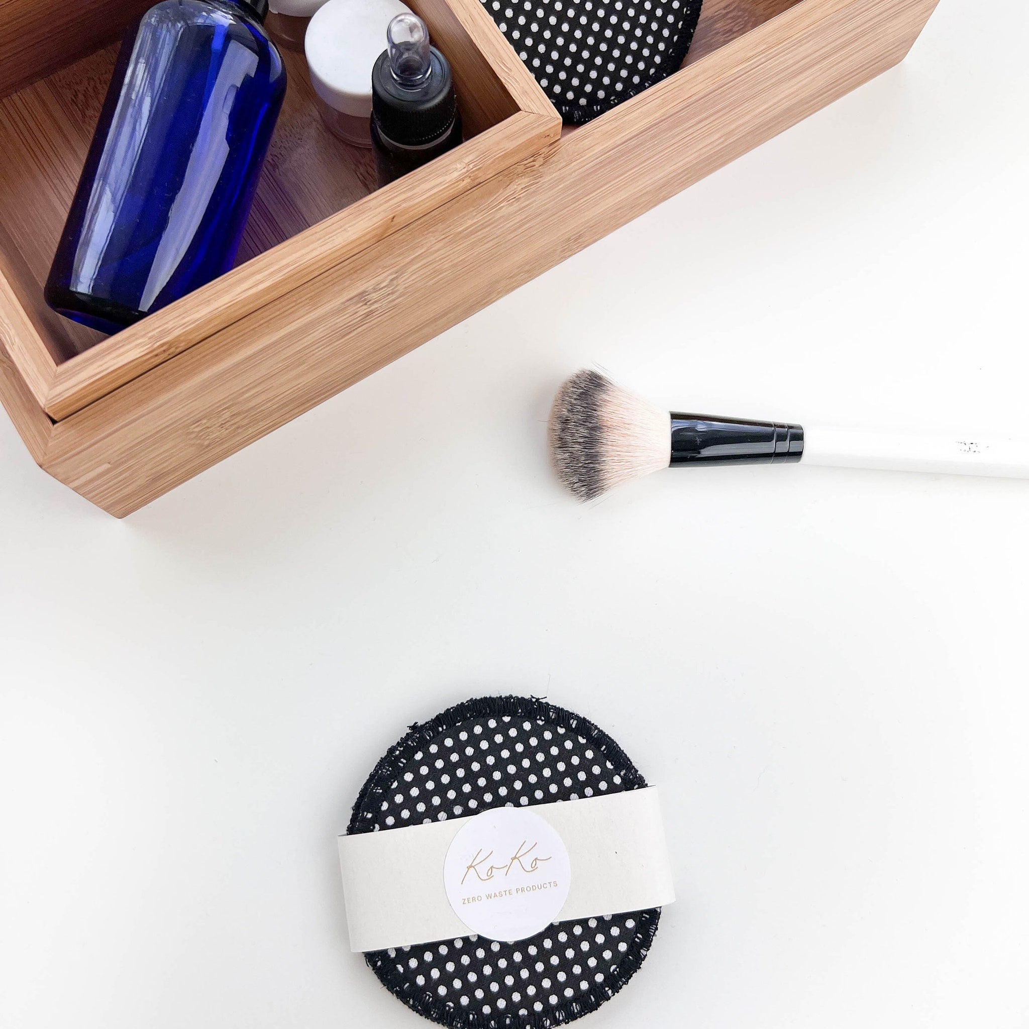 Reusable makeup pads with black polka dot pattern and Ko-Ko branding, white band