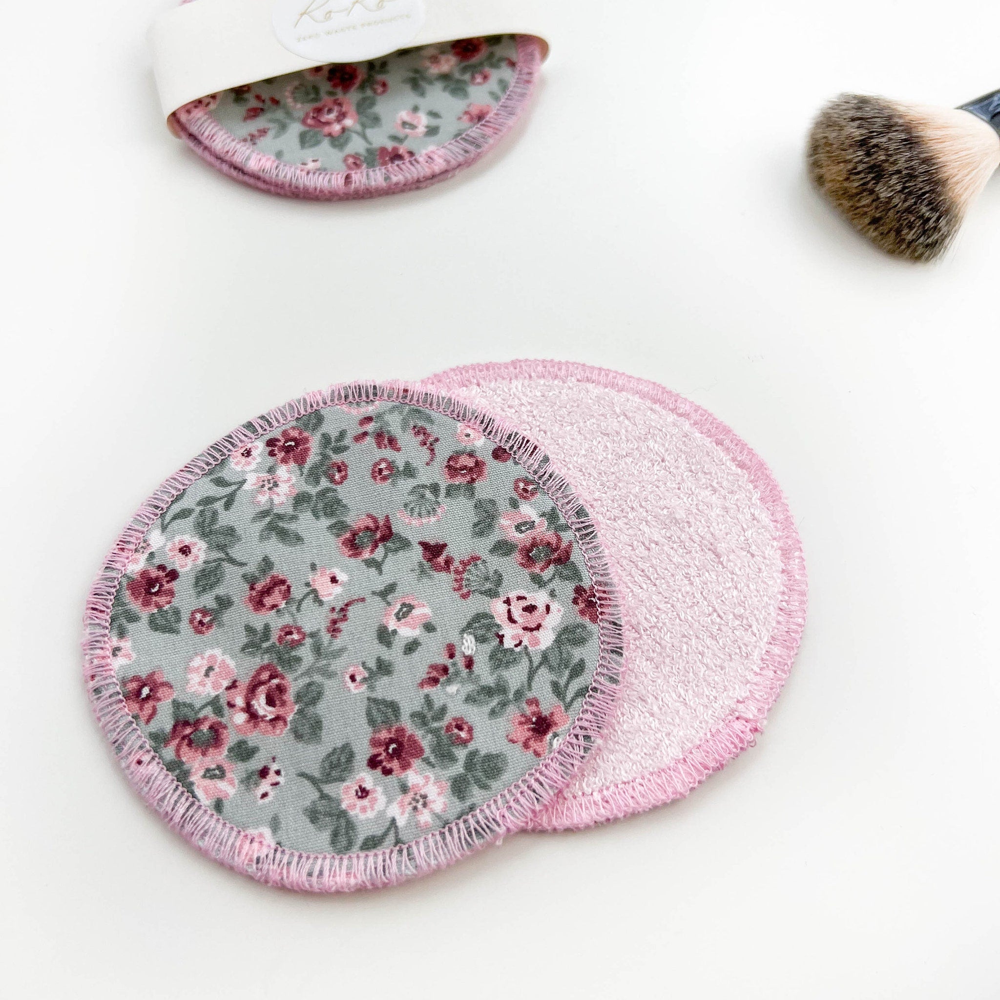 Reusable makeup remover pads with floral pattern and pink trim, Koko brand visible