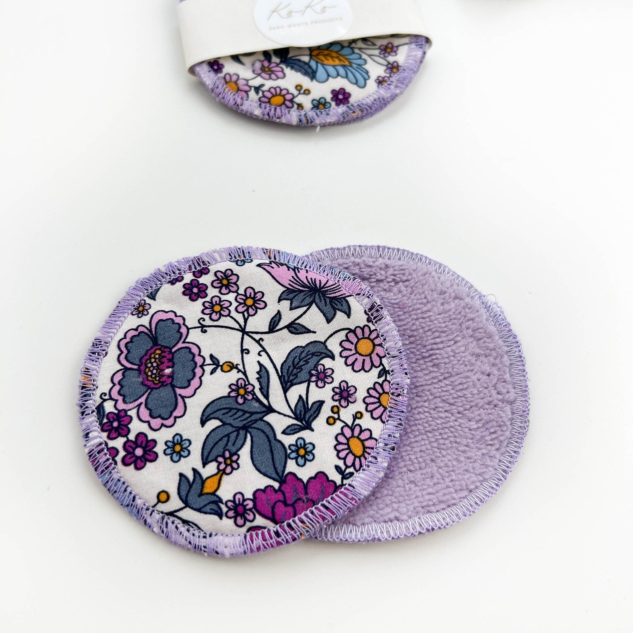 Reusable makeup remover pads with floral print, purple trim, and soft material