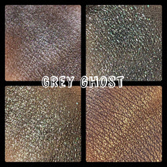 Close-up of pressed multichrome eyeshadow pan shifting from grey to iridescent hues with shimmer finish