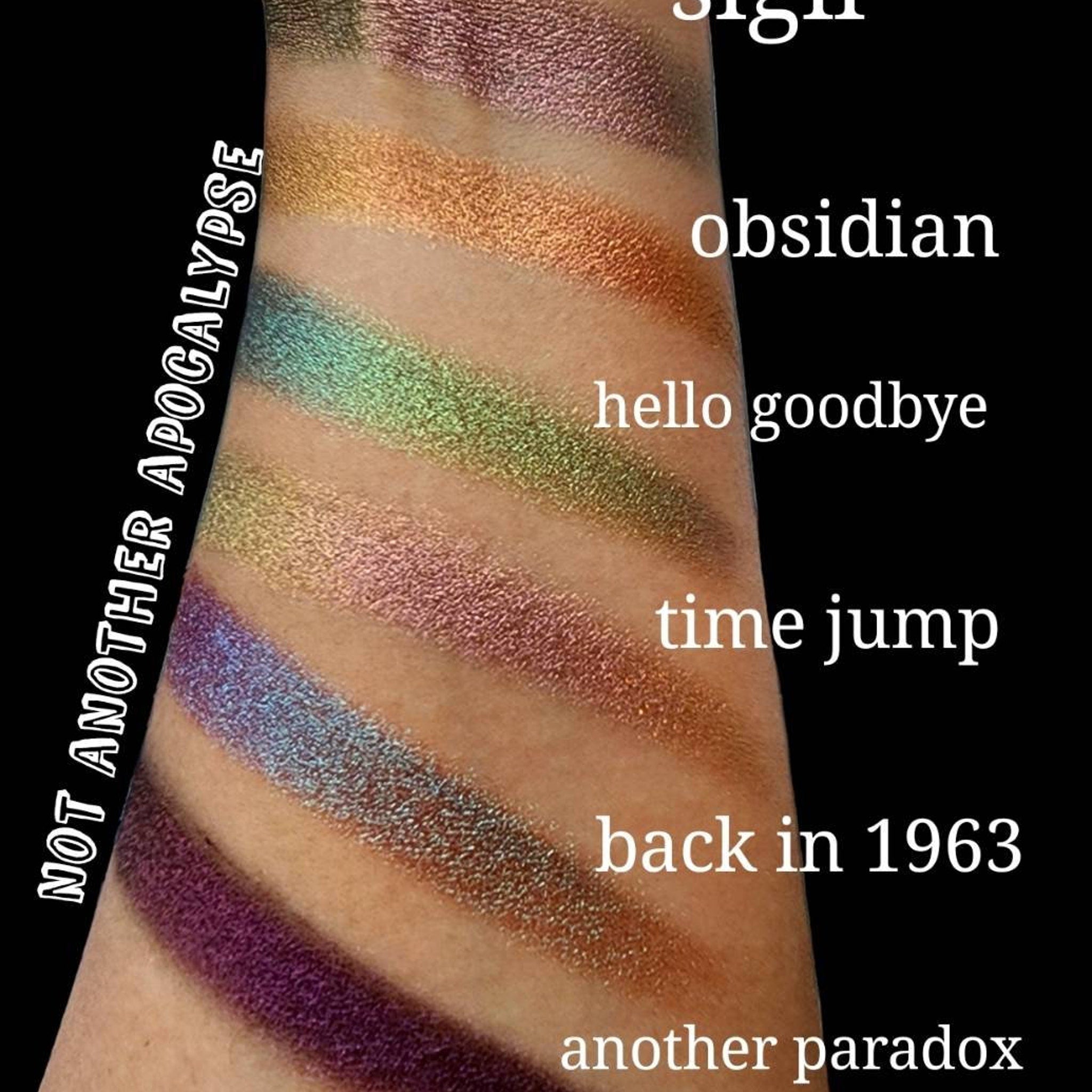Open compact showing pressed trichrome chameleon eyeshadow with vegan shimmer in gradient color shift