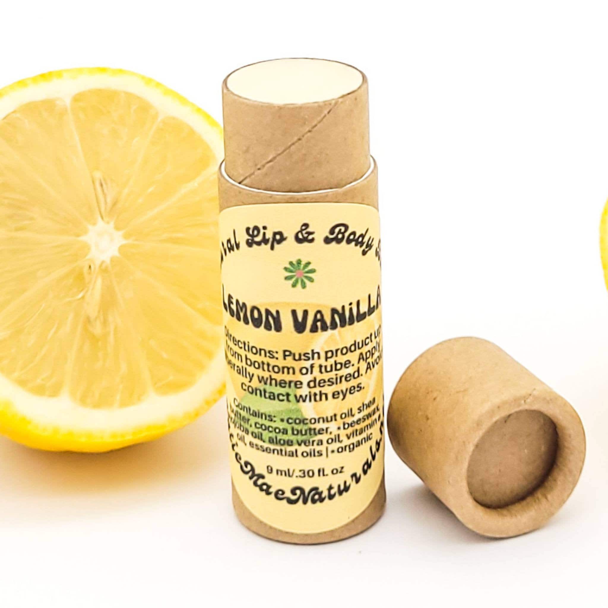 Lip balm tube, brown cardboard, yellow label with text, lemon slice visible
