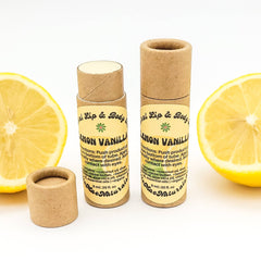 Lip balm tubes with brown cardboard, white label, and Mae Naturals branding, next to lemon slices