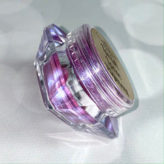 Side view of Lavish Pigment Extraterrestrial Eyeshadow pot showing vibrant purple and blue duo-chrome shimmer