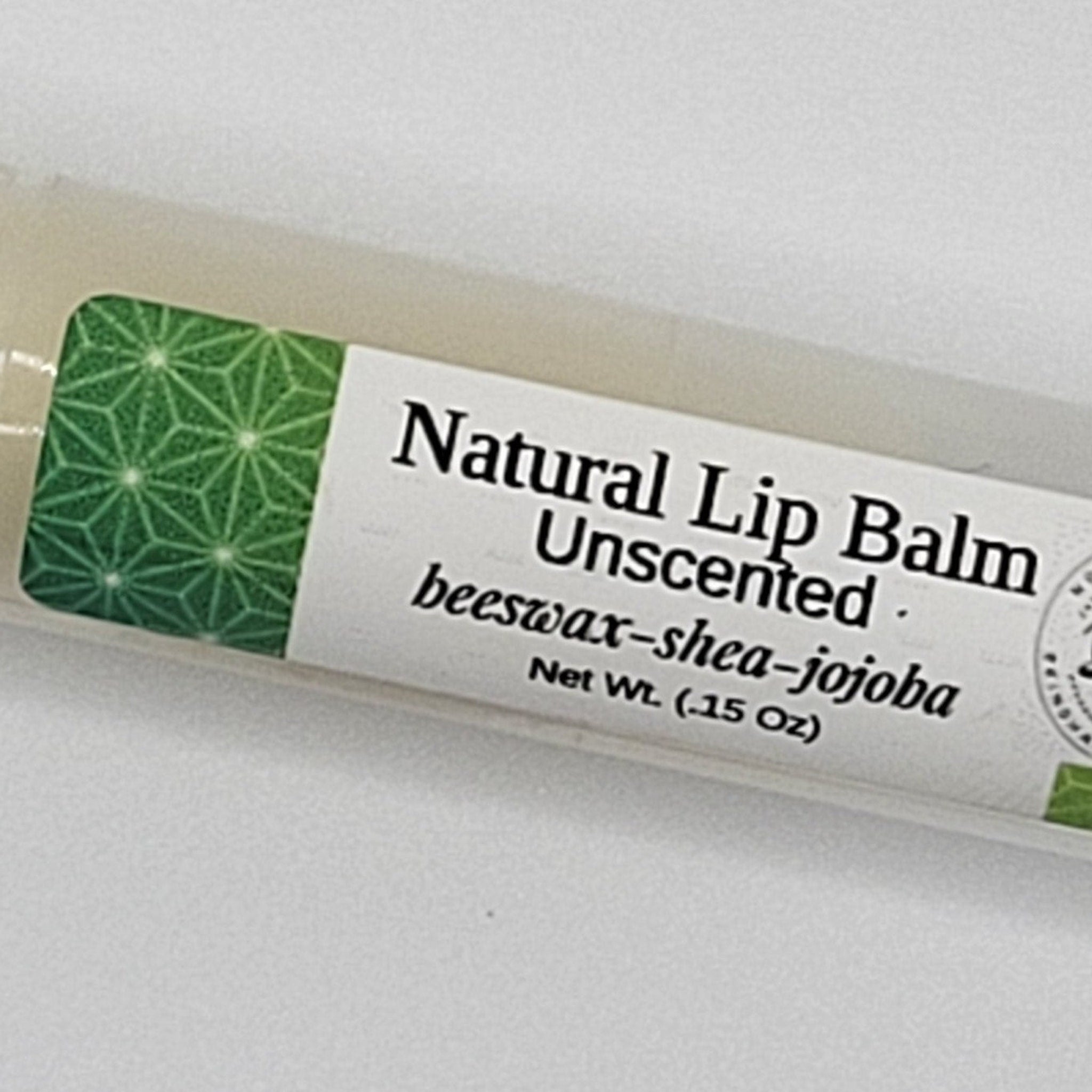 Lip balm tube with green geometric pattern label, white text, and beige tube