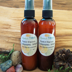 Facial cleanser spray, brown glass bottles with black spray tops, Quench brand label visible