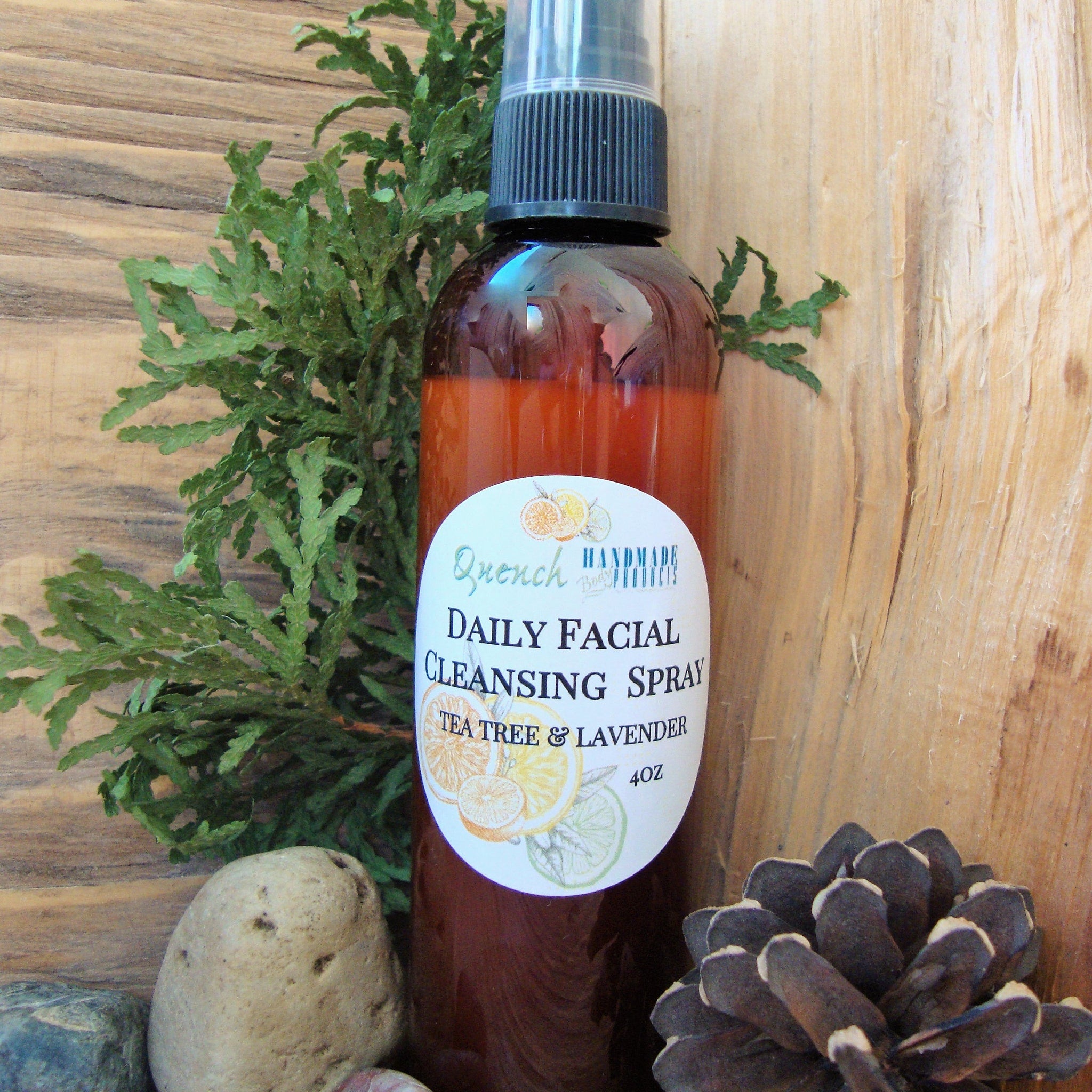 Daily facial cleansing spray bottle with brown liquid, black cap, and white label with text and citrus illustrations