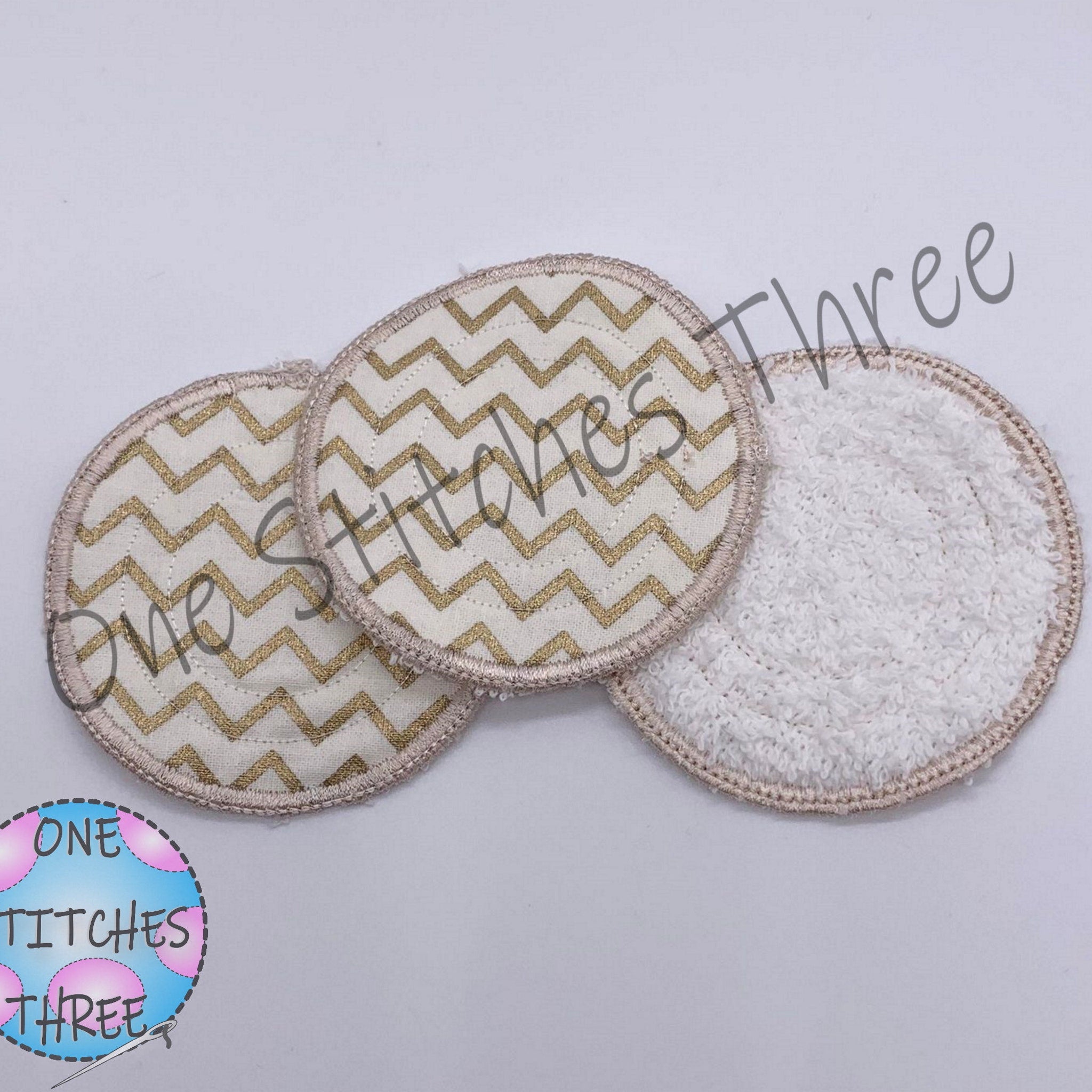 Reusable facial rounds with gold chevron pattern and One Stitches Three branding