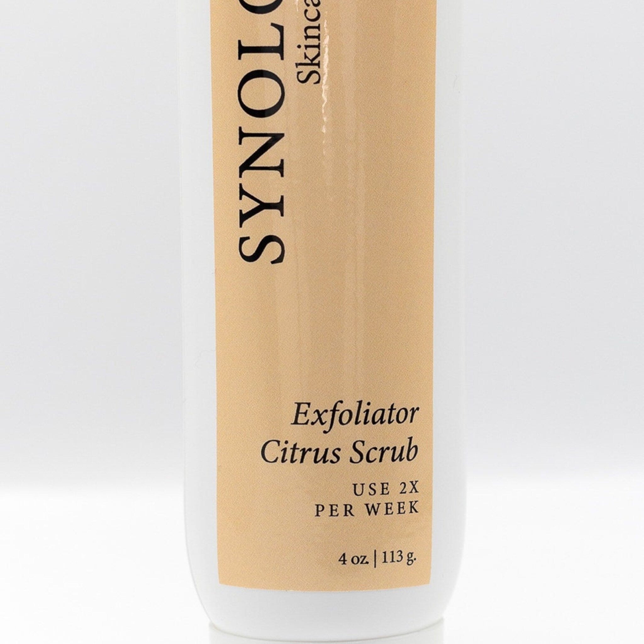 Exfoliator bottle with white and tan label, vertical text, and product information