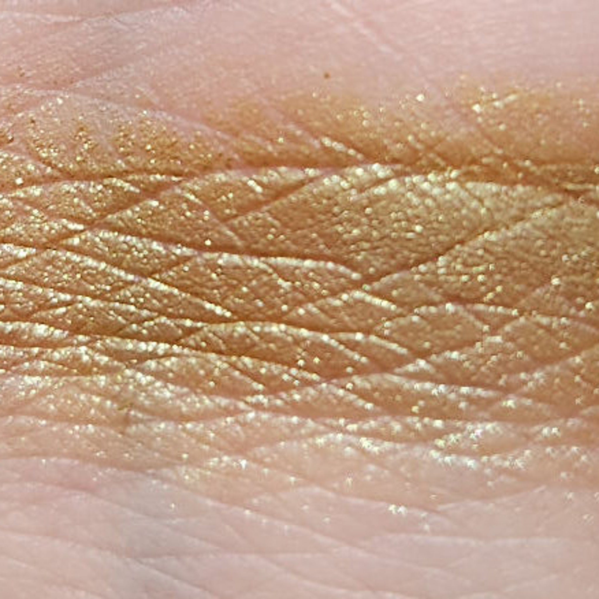 Close-up of the Eye of Newt Shadow Palette showing four richly pigmented matte and shimmer shades in deep plum, bronze, emerald, and gold.