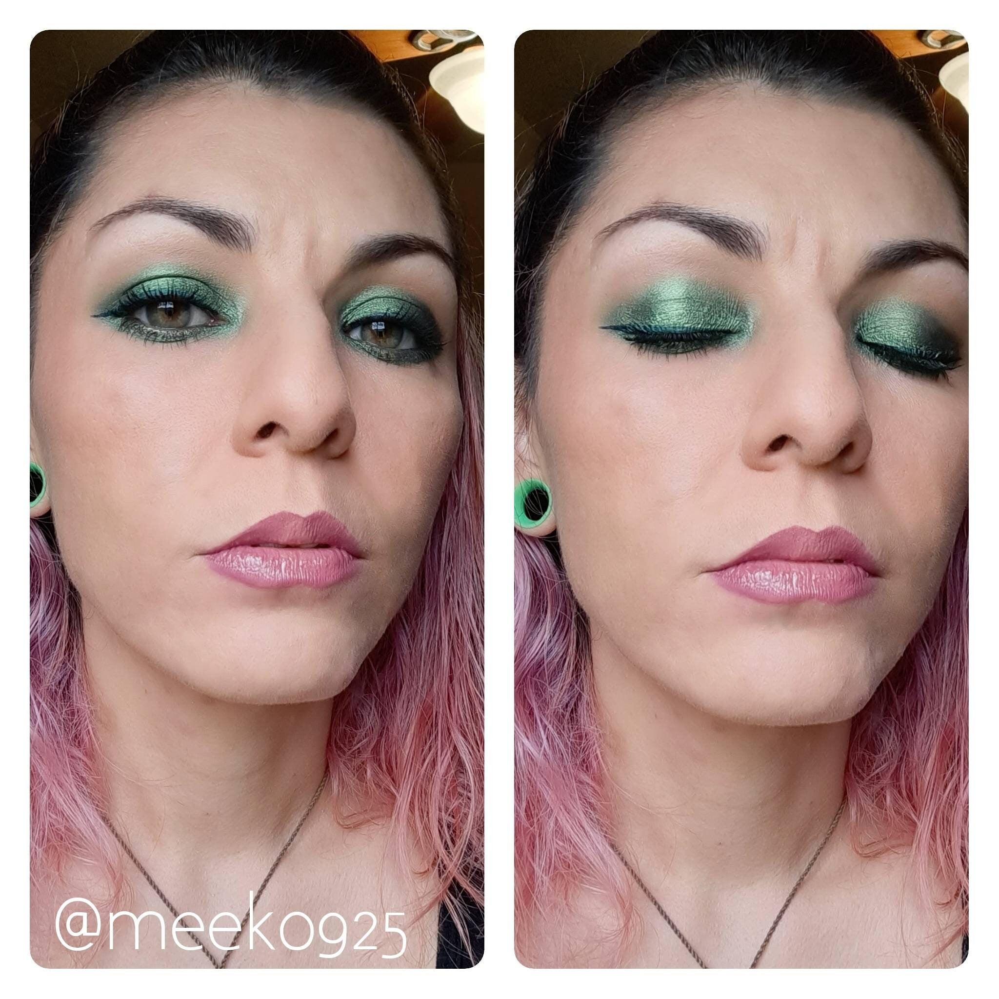 Green eyeshadow with black eyeliner and pink lipstick on a woman's face, with pink hair