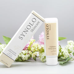 Exfoliator Citrus Scrub product with white and tan packaging, Synolo Skincare brand, with flowers