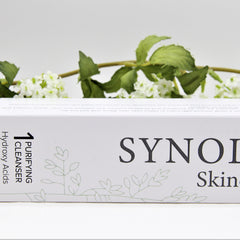 Purifying cleanser box, white with green leaf design, "SYNOL" text, and floral background.