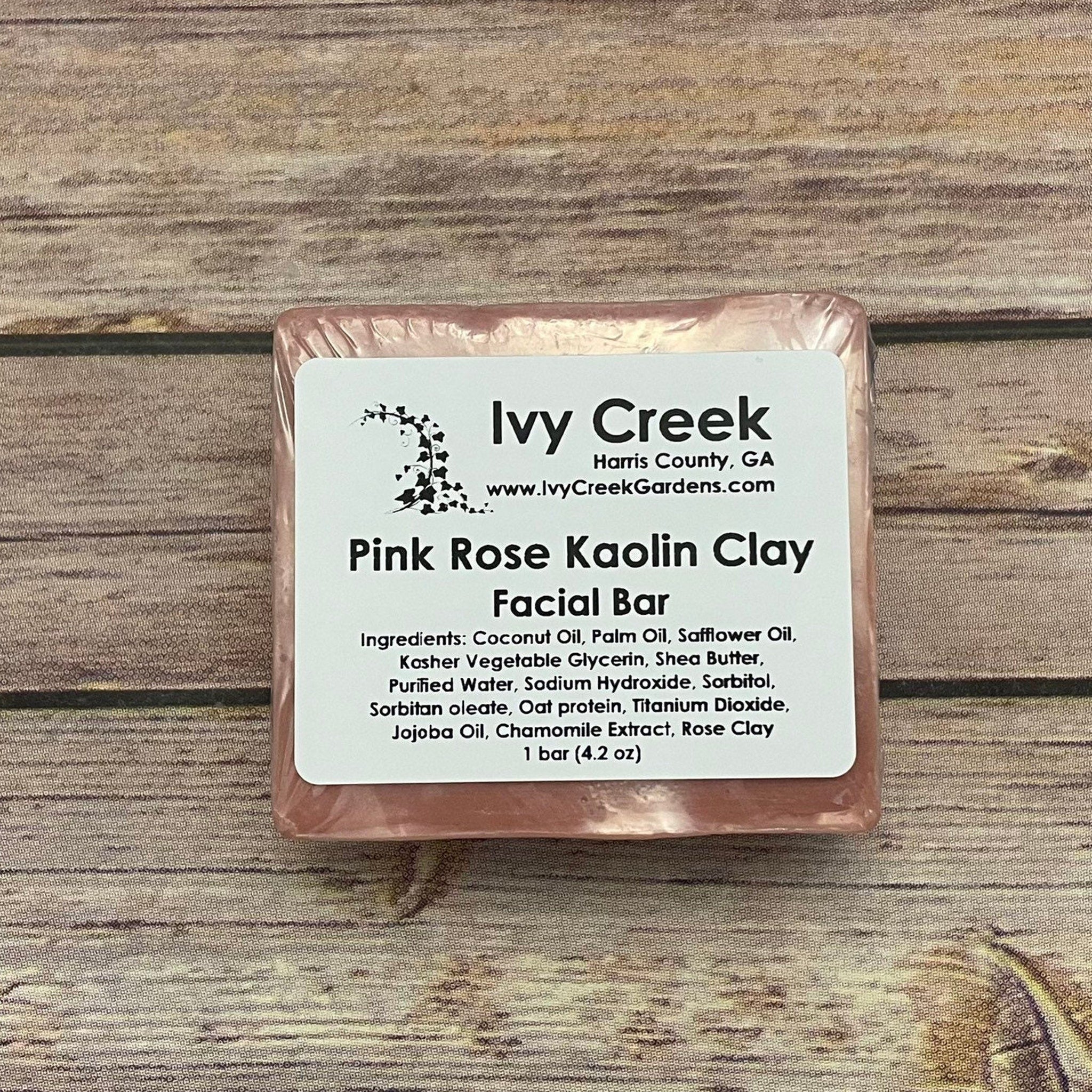Facial bar of pink color, wrapped, with Ivy Creek label on wood background