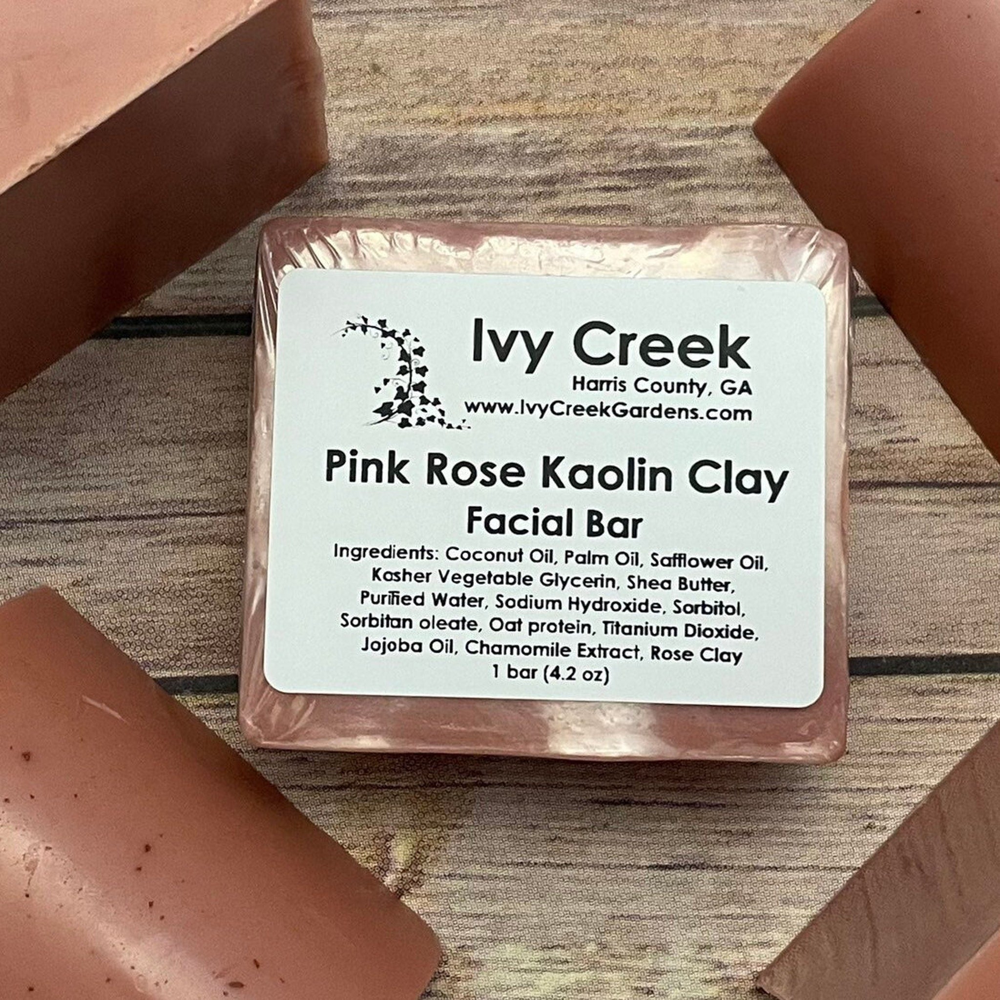 Pink Rose Kaolin Clay Facial Bar, pink rectangular bar, wrapped, Ivy Creek label visible, on wooden surface