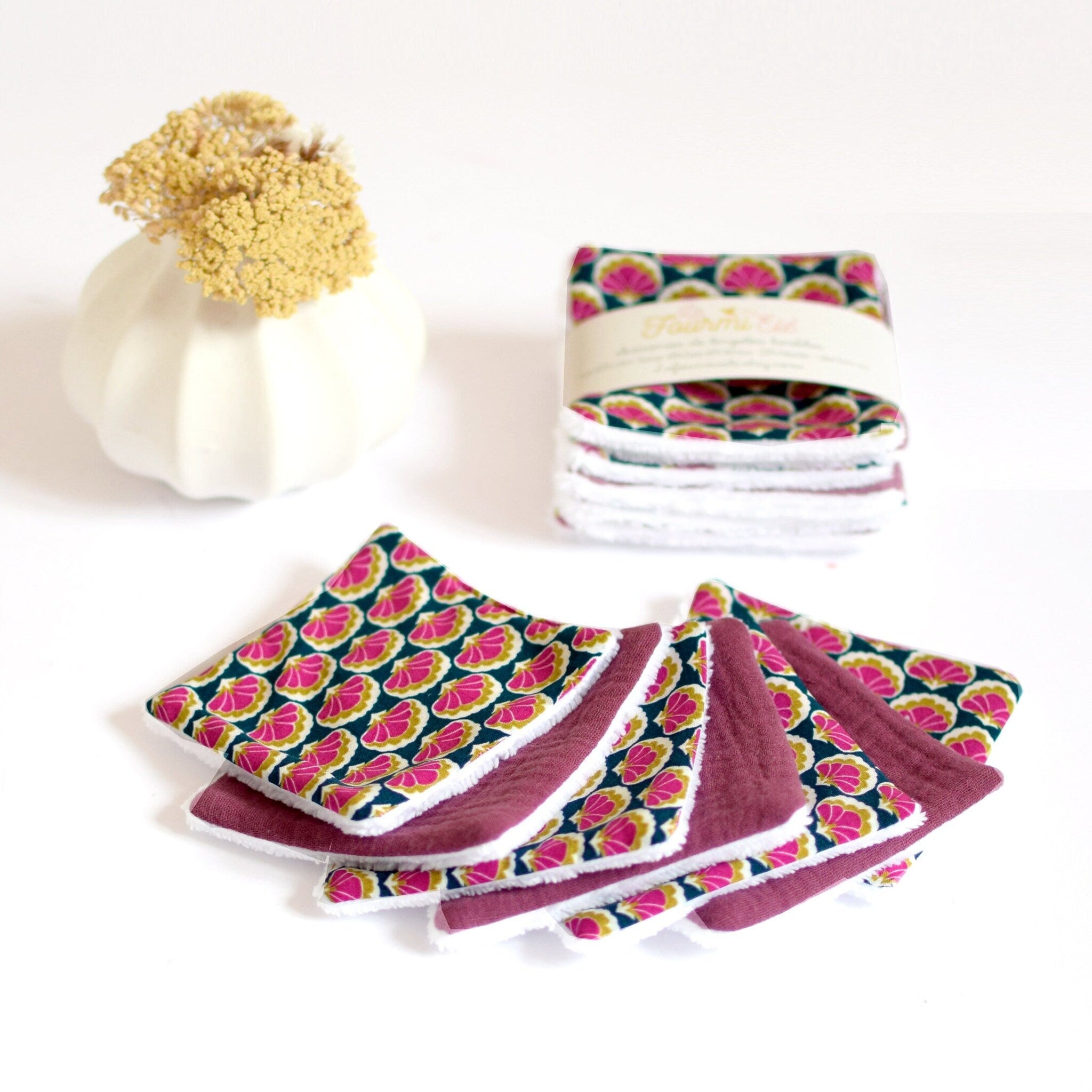 Reusable makeup remover pads with floral pattern, pink and teal fabric, and white trim