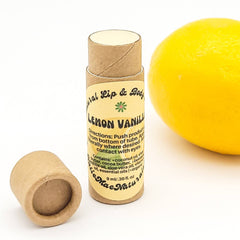 Lip balm tube with brown cardboard, yellow label, and lemon next to it