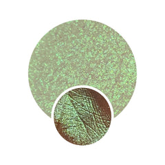 Pressed eyeshadow pan with magical neon green and pink duochrome shimmer, vegan folklore collection