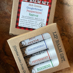 Lip balm gift set in cardboard box with white tubes, Crystal Lake Soap Co. branding, and colored text labels