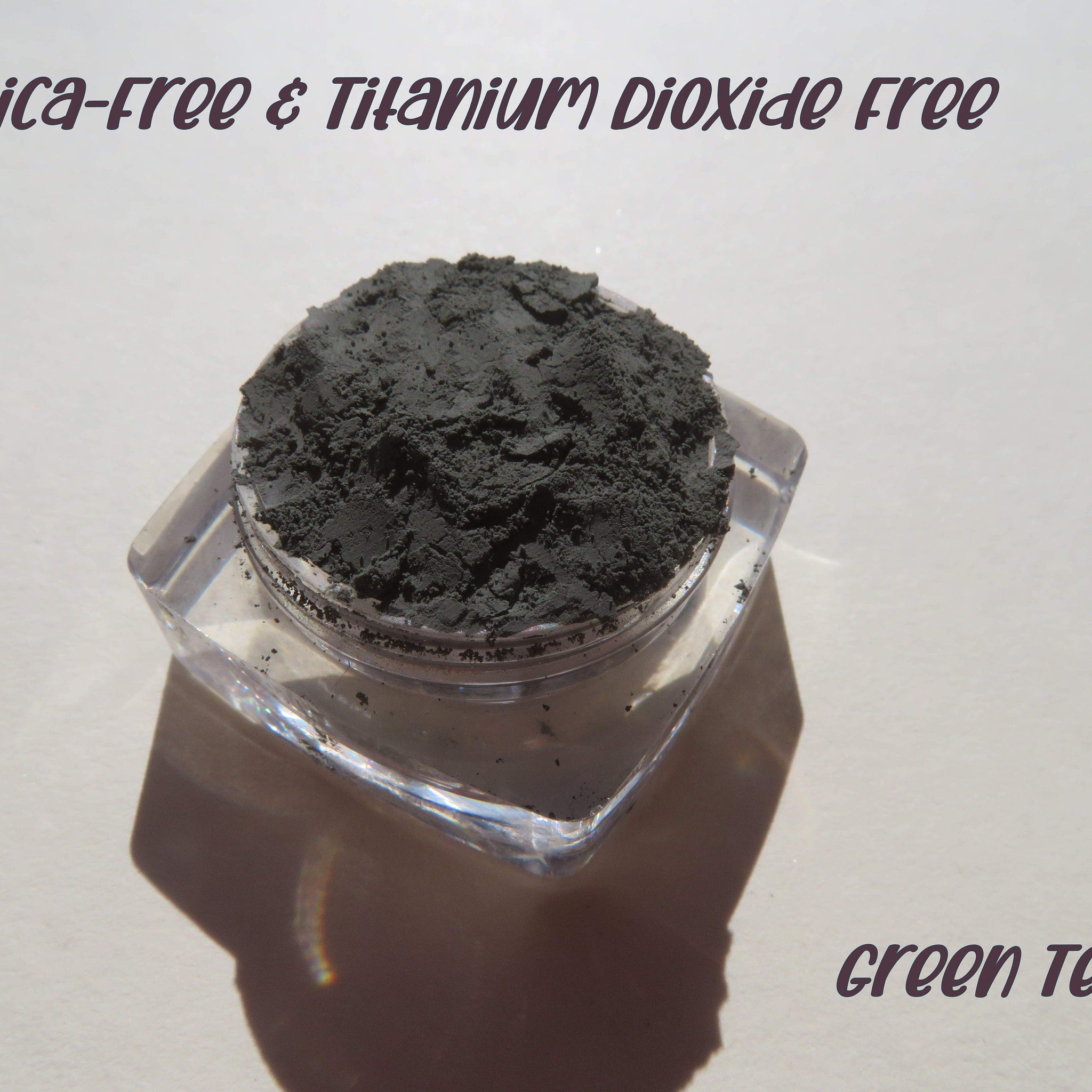 Dark matte green tea mineral eyeshadow in loose powder form with mica, vegan and cruelty-free, shown in open jar