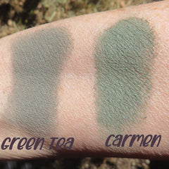 Dark matte green tea loose mineral eyeshadow in open jar with soft mica powder texture