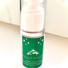 Face cleanser bottle with white and green label, clear pump, and Truly Green branding on display