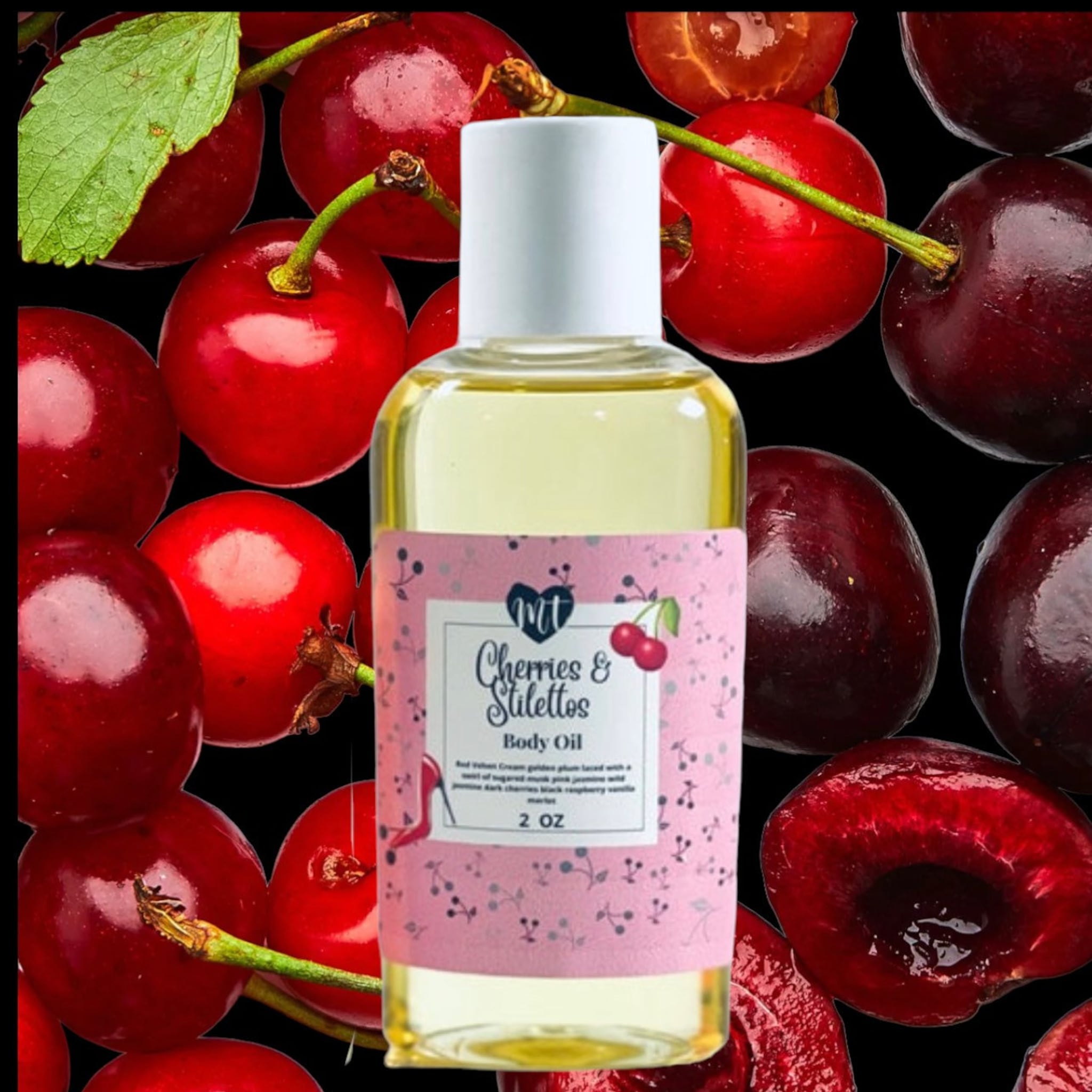 Body oil bottle with white cap, pink label, and red cherries on black background, "Cherries & Stilettos" brand