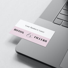 Business card with white and pink color, text "Botox & Fillers" on a laptop surface